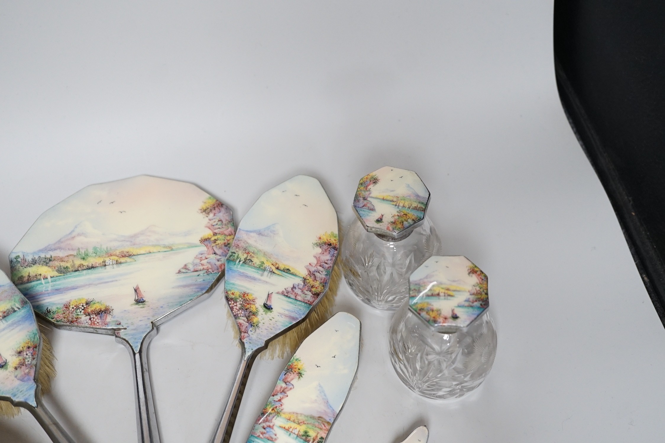 A twelve piece chrome plated and enamel dressing table set